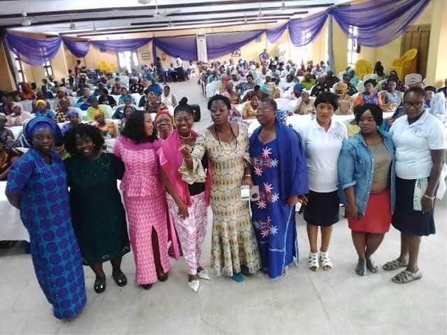 Great Mind Achievers leader with women at a community event